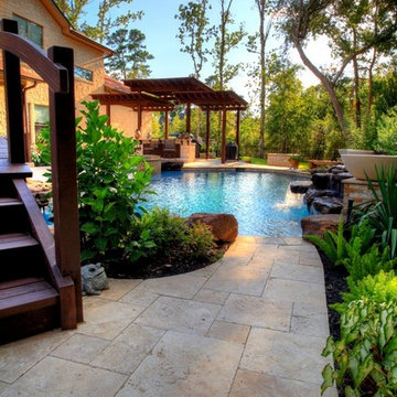 Natural Pool with rock waterfall, bridge, spa, and pergola