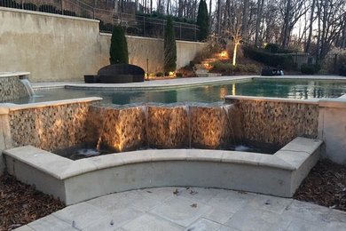 Example of a trendy tile and custom-shaped infinity pool fountain design in Nashville