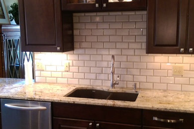 Example of a kitchen design in Cincinnati with shaker cabinets and dark wood cabinets