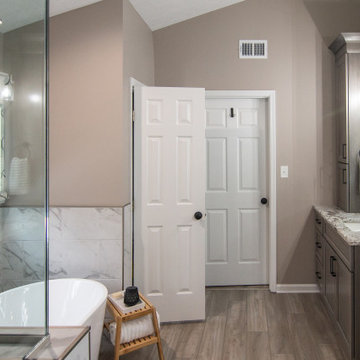 Traditional Master Bathroom With Warm Tones, Stand Alone Tub & Walk In Shower