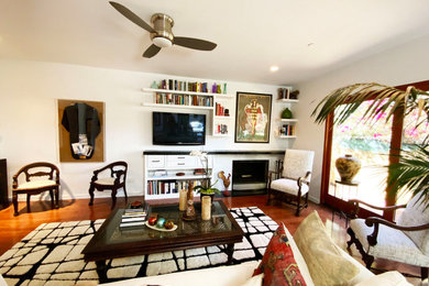 Inspiration for a mid-sized eclectic formal and open concept medium tone wood floor and brown floor living room remodel in Los Angeles with white walls, a corner fireplace and a wall-mounted tv