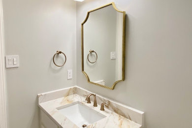 Transitional bathroom photo in Dallas with marble countertops