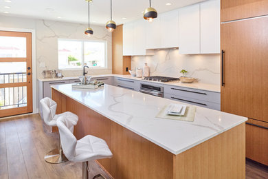 Kitchen - modern kitchen idea in Vancouver with an island
