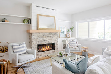 This is an example of a transitional living room in Vancouver with grey walls, medium hardwood floors, a ribbon fireplace, a stone fireplace surround and brown floor.