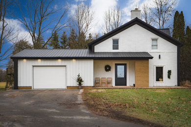 Mid-sized cottage white one-story mixed siding house exterior idea in Other with a metal roof