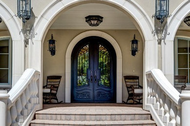 Photo of a large traditional front door in Denver with beige walls, a double front door and a metal front door.