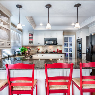 Mid-sized traditional enclosed kitchen ideas - Enclosed kitchen - mid-sized traditional u-shaped medium tone wood floor enclosed kitchen idea in Orange County with an undermount sink, raised-panel cabinets, white cabinets, quartz countertops, multicolored backsplash, black appliances and no island