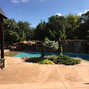 Custom Pool with Beach Entry and Large Waterfall