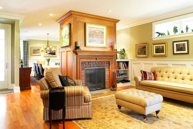 Example of a mid-sized classic formal and open concept light wood floor living room design in Toronto with beige walls, a two-sided fireplace, a brick fireplace and no tv