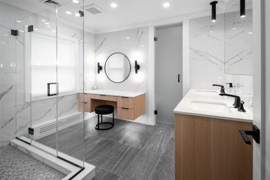 Mid-sized minimalist white tile and marble tile porcelain tile, gray floor and double-sink bathroom photo in New York with flat-panel cabinets, light wood cabinets, a wall-mount toilet, white walls, an undermount sink, quartz countertops, a hinged shower door, white countertops and a floating vanity