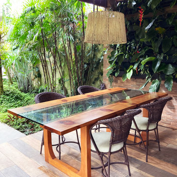 Rustic Outdoor Dining: Wooden Table, Green Wall, Jute Pendant Light - Home Exten
