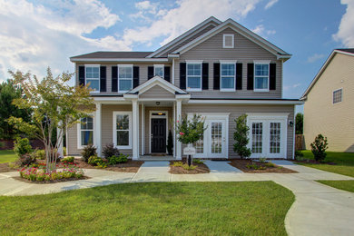 Inspiration for a mid-sized timeless beige two-story vinyl house exterior remodel in Atlanta with a hip roof and a shingle roof