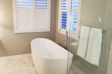 Large transitional master light wood floor and beige floor bathroom photo in Other with white cabinets and brown walls