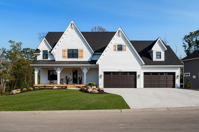 Cottage white two-story exterior home idea in Minneapolis with a shingle roof