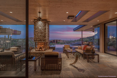 Large trendy open concept ceramic tile living room photo in Phoenix with beige walls, a ribbon fireplace, a stone fireplace and a wall-mounted tv