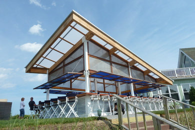 Inspiration for a large contemporary dock remodel in New York with a roof extension