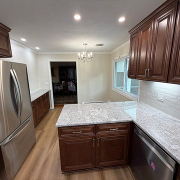 USCD cabinetry accompanied granite countertops, porcelain tile backsplash and Ca