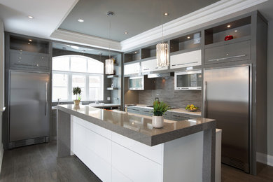 This is an example of a large modern l-shaped separate kitchen in Toronto with an undermount sink, flat-panel cabinets, grey cabinets, granite benchtops, brown splashback, matchstick tile splashback, stainless steel appliances, dark hardwood floors, with island, brown floor and brown benchtop.