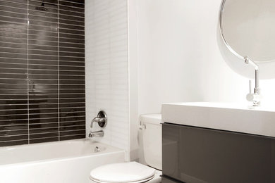 Inspiration for a modern kids' gray tile and glass tile porcelain tile bathroom remodel in Toronto with an integrated sink, flat-panel cabinets, gray cabinets, quartz countertops, a one-piece toilet and gray walls