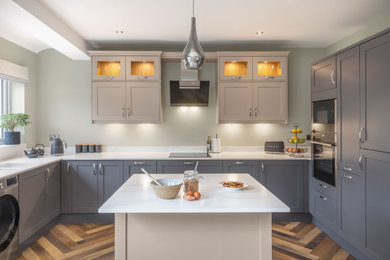 Medium sized modern grey and white u-shaped kitchen/diner in Other with shaker cabinets, grey cabinets, quartz worktops, an island and white worktops.