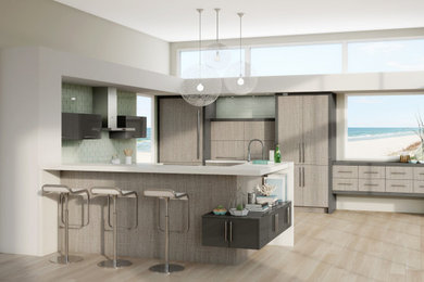 Eat-in kitchen - mid-sized asian u-shaped porcelain tile and beige floor eat-in kitchen idea in Chicago with an undermount sink, flat-panel cabinets, light wood cabinets, quartz countertops, green backsplash, glass tile backsplash, stainless steel appliances, a peninsula and white countertops