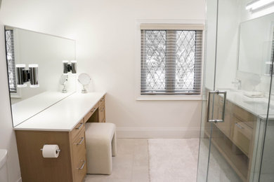 Example of a minimalist master double-sink bathroom design in Toronto with quartz countertops and a built-in vanity