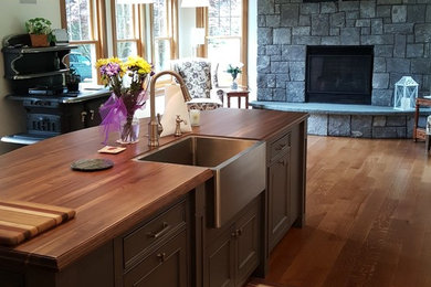 Elegant kitchen photo in New York with an island