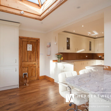 Ivory Mackintosh kitchen with stunning copper glass splashback