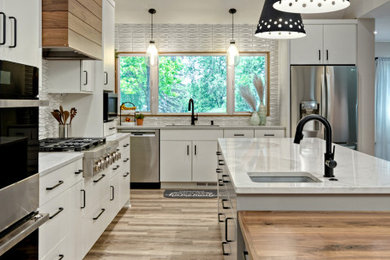 Inspiration for a large contemporary l-shaped vinyl floor, beige floor and vaulted ceiling open concept kitchen remodel in Minneapolis with an undermount sink, flat-panel cabinets, white cabinets, quartz countertops, gray backsplash, ceramic backsplash, stainless steel appliances, an island and white countertops