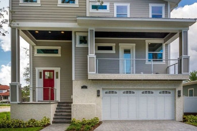 Mid-sized transitional beige split-level wood exterior home idea in Tampa