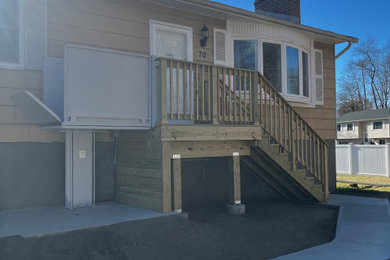Mid-sized wood railing front porch idea in New York with decking