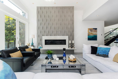 Inspiration for a large contemporary open concept gray floor and light wood floor living room remodel in Vancouver with white walls, a stone fireplace and a ribbon fireplace