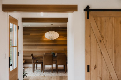 Example of a mid-sized minimalist wood wall enclosed dining room design in San Francisco with brown walls