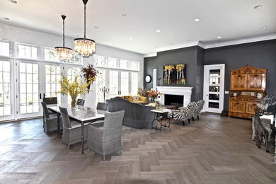 Inspiration for a large transitional open concept and formal medium tone wood floor and brown floor living room remodel in Omaha with white walls, a standard fireplace, no tv and a plaster fireplace