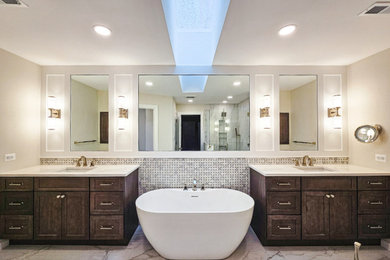 Photo of a transitional master bathroom in DC Metro with brown cabinets, a freestanding tub, a corner shower, multi-coloured tile, ceramic tile, ceramic floors, an undermount sink, engineered quartz benchtops, multi-coloured floor, a hinged shower door, white benchtops, an enclosed toilet, a double vanity and a built-in vanity.