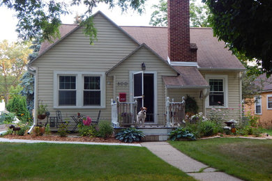 Inspiration for a large contemporary yellow two-story vinyl house exterior remodel in Other