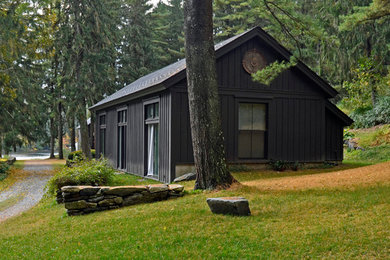 Mid-sized mountain style gray one-story wood exterior home photo in New York with a shingle roof