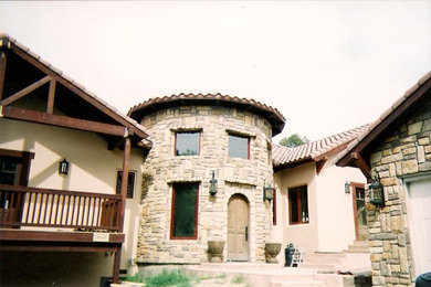 Inspiration for a large timeless beige two-story stone gable roof remodel in San Luis Obispo