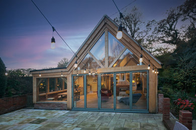 Modern timber frame extension onto an traditional farmhouse