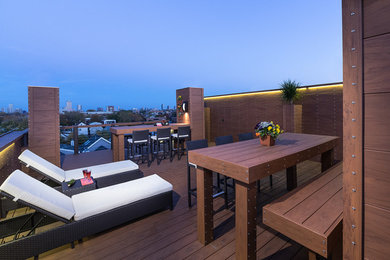 This is an example of a large contemporary rooftop deck in Chicago with no cover and a container garden.