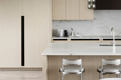 Trendy kitchen photo in Calgary with flat-panel cabinets, light wood cabinets and an island