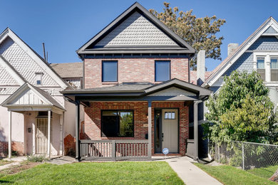 Inspiration for a mid-sized red two-story brick exterior home remodel in Denver with a shingle roof