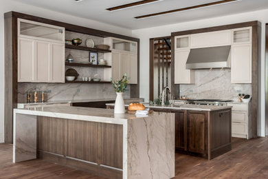 Photo of a modern eat-in kitchen in Salt Lake City with shaker cabinets, white cabinets, quartzite benchtops, grey splashback, stainless steel appliances, dark hardwood floors, multiple islands, brown floor and grey benchtop.