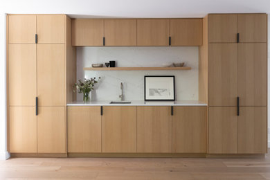 Home bar - contemporary light wood floor home bar idea in San Francisco with an undermount sink, flat-panel cabinets, quartz countertops, white backsplash, quartz backsplash and white countertops