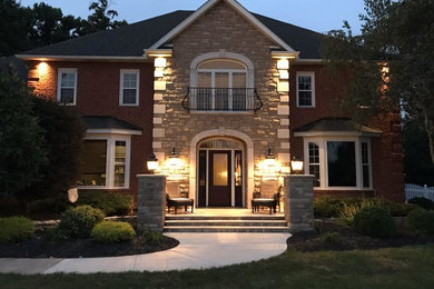 Mid-sized elegant tile front porch photo in Other