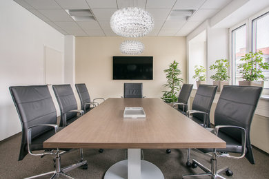 Large trendy freestanding desk carpeted study room photo in Other with beige walls