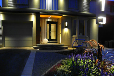 This is an example of a mid-sized modern full sun front yard concrete paver landscaping in Ottawa for summer.