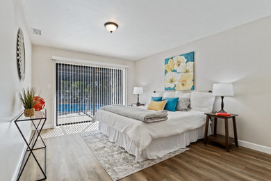 Bedroom - mid-sized traditional guest laminate floor and brown floor bedroom idea in Tampa with black walls and no fireplace