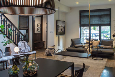 Inspiration for a mid-sized modern open concept medium tone wood floor and brown floor living room remodel in Chicago with white walls, a standard fireplace, a wood fireplace surround and no tv