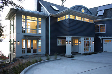 Inspiration for a large traditional three-storey blue house exterior in Seattle with concrete fiberboard siding, a gable roof and a mixed roof.